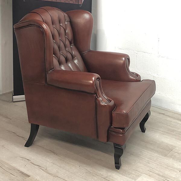 Bergère Chesterfield club de profil. La basane utilisée pour le recouvrement est marron